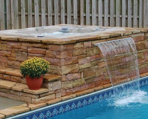 Outdoor hot tub installation with a waterfall.