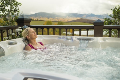 Woman relaxing in the Capri hot tub from Sundance Spas.