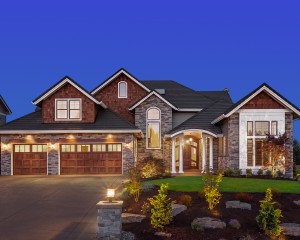 Beautiful house with great curb appeal illuminated at dusk.